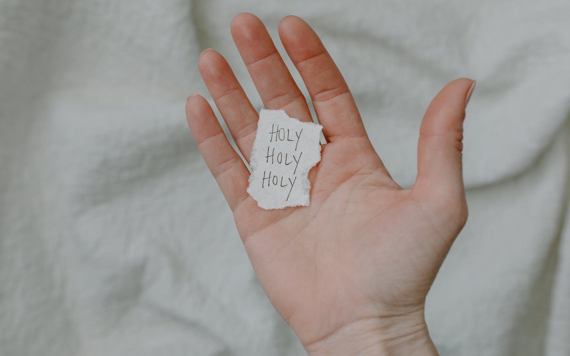 Paper with Holy Holy Holy written